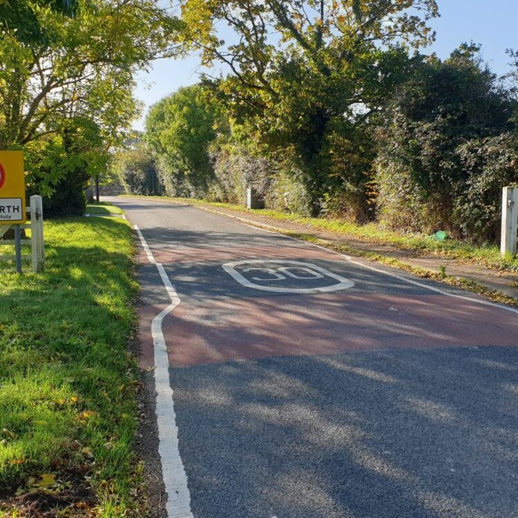 Country road with 30mph speed signs